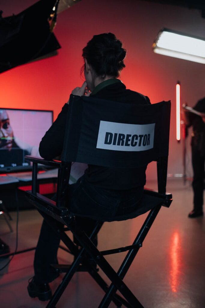pexels photo 8088374 Director sits on chair in moody film studio, overseeing production setup.