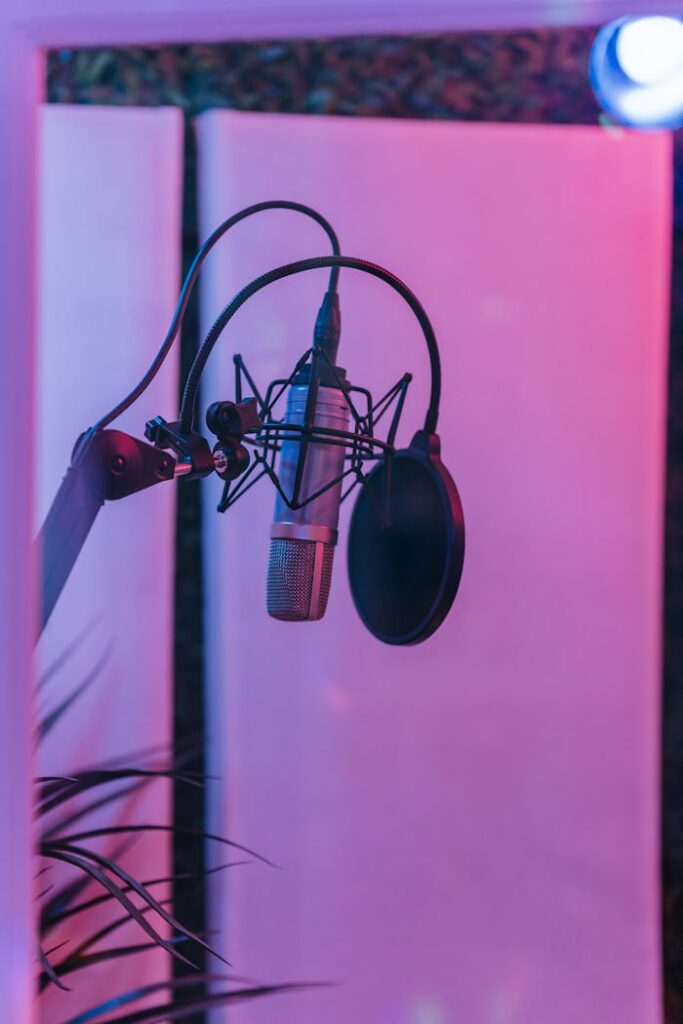 pexels photo 8132531 Close-up of a microphone setup in a moody recording studio environment.